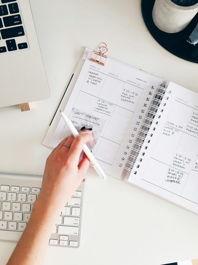 person-holding-notepad-and-pen-flat-lay-photography-flrm0z3meoa making appointments